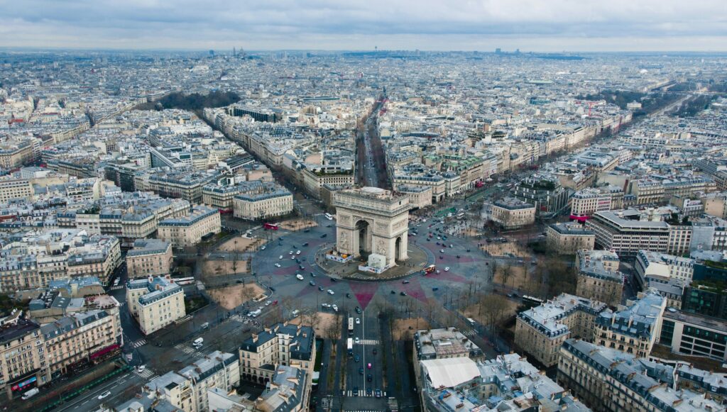 Aerial view photo centred on Arc de Triomphe, Paris, France, by Rodrigo Kugnharski on Unsplash